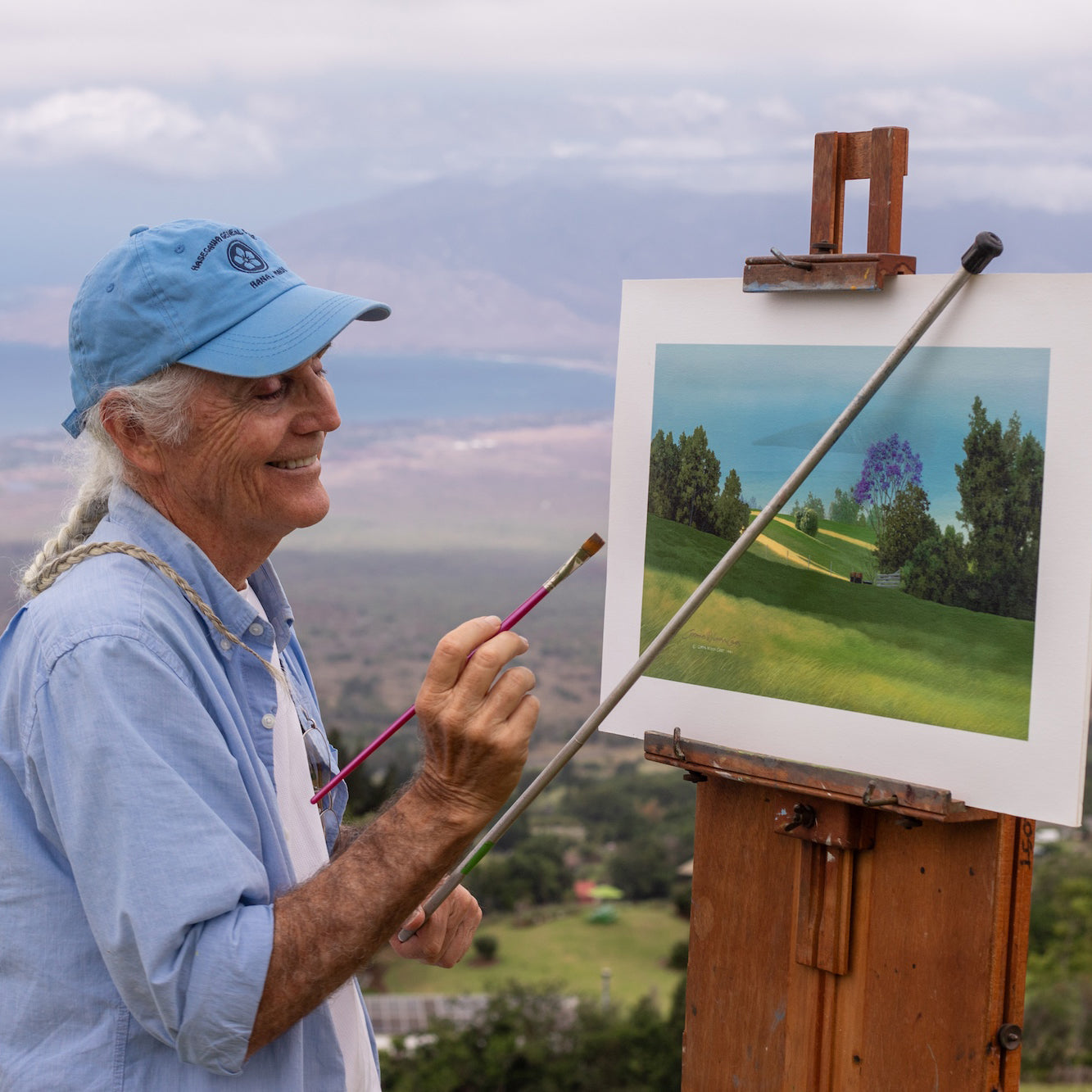 Curtis Wilson Cost painting at his easel above Kula